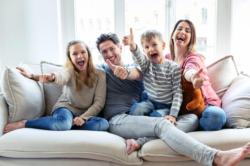 Happy Family giving Thumbs Up Indoors